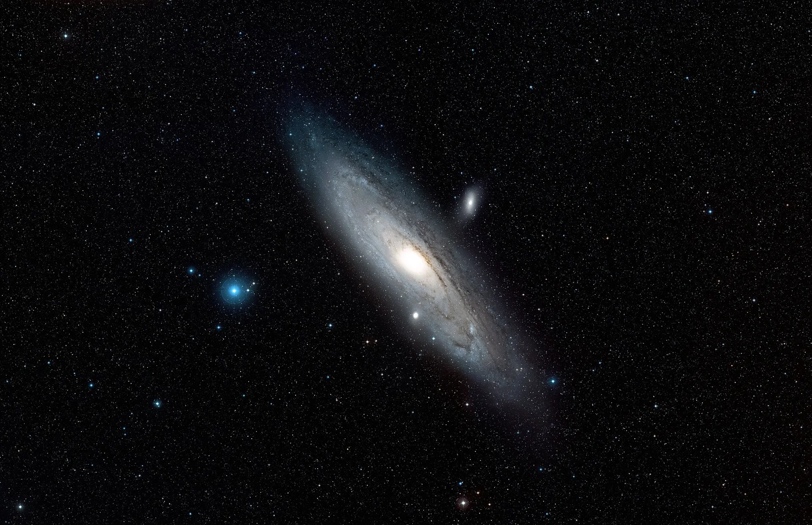 This ground-based image shows the full extent of the Andromeda Galaxy, also known as Messier 31 or M 31. The Andromeda Galaxy appears very l