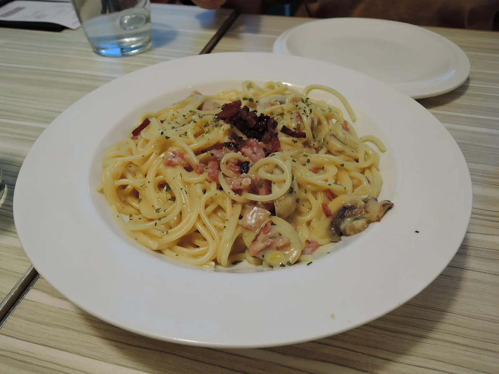 Bacon and mushroom with cream sauce pasta in western restaurant in shopping mall in yuen long