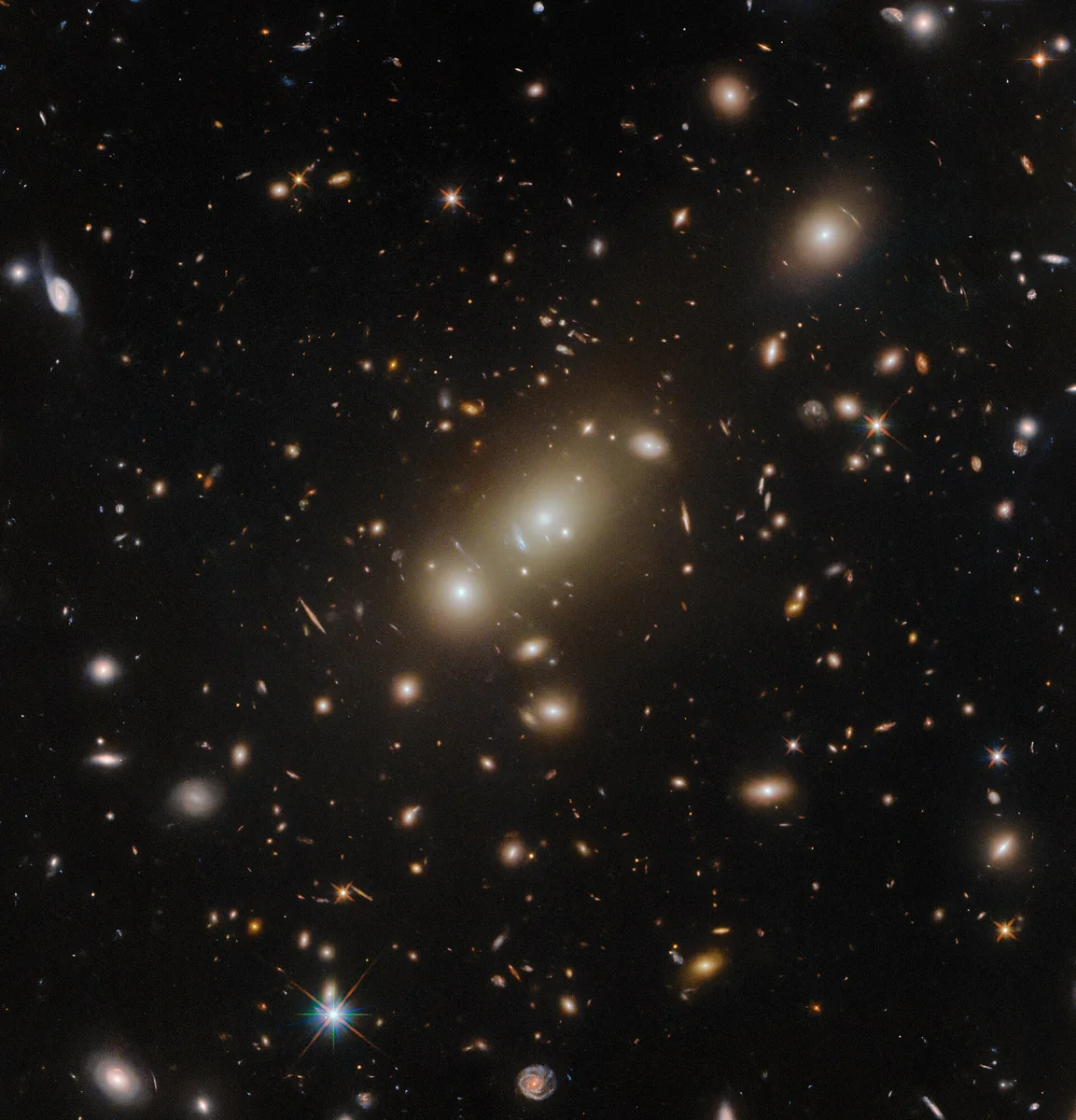 The truly massive galaxy cluster 2MASX J05101744-4519179 basks in the centre of this image from the NASA/ESA Hubble Space Telescope. This di
