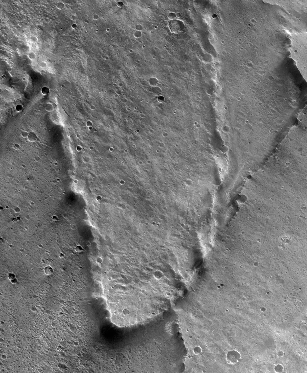 Ejecta lobe of Yuty crater, clearly showing the rampart along the edge, on Mars. Image ID P14_006637_2025_XI_22N034W Center Lat 22.51° Cente