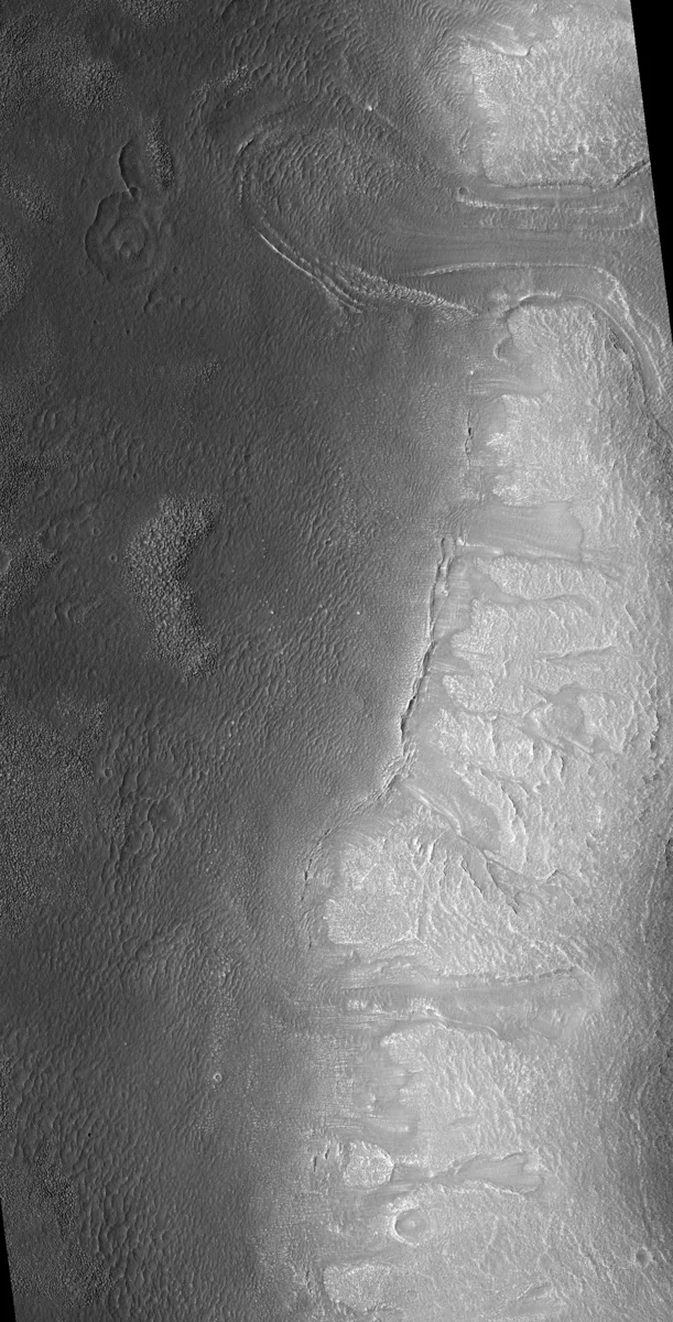 This region contains many mesas surrounded by lobate debris aprons that are thought to be ice-rich. These aprons have been interpreted as a